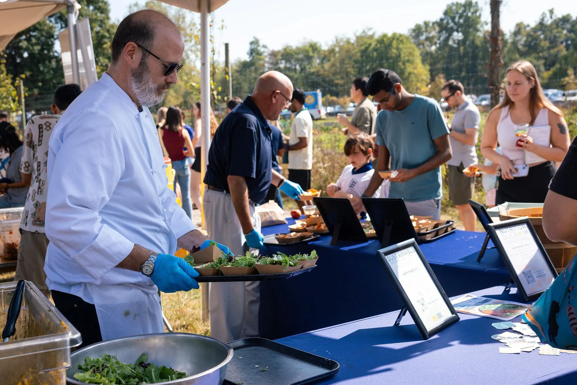 Chef serving produce samples at Harvest Fest